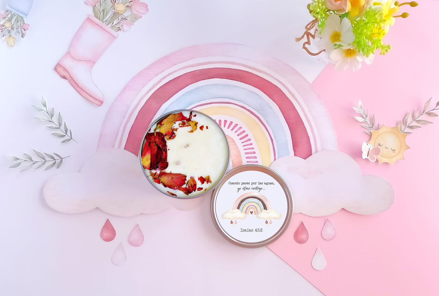 Decorative candle with floral design on a pink background with rainbow and cloud elements.