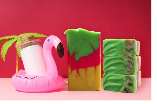 Three colorful soap bars with a pink flamingo float and palm leaf on a red background
